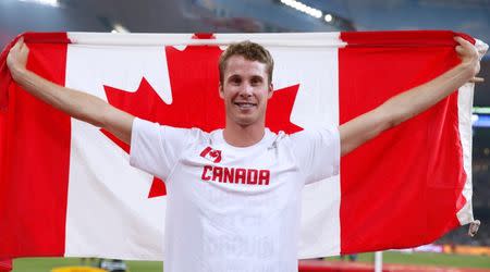 Derek Drouin of Canada celebrates after winning gold in the men's high jump final during the 15th IAAF World Championships at the National Stadium in Beijing, China August 30, 2015. REUTERS/Phil Noble