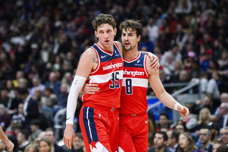 Washington Wizards center Mike Muscala (35) and forward Deni Avdija (8) celebrate during first half of an NBA basketball game against the Toronto Raptors in Toronto on Monday, Nov. 13, 2023. (Christopher Katsarov/The Canadian Press via AP)