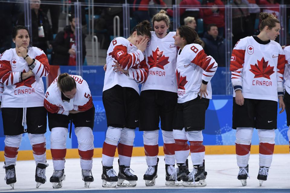 <p>The Canada team reacts on the podium during the medal ceremony after losing the women’s ice hockey gold medal game to the US during the Pyeongchang 2018 Winter Olympic Games at the Gangneung Hockey Centre in Gangneung on February 22, 2018. / AFP PHOTO / JUNG Yeon-Je </p>