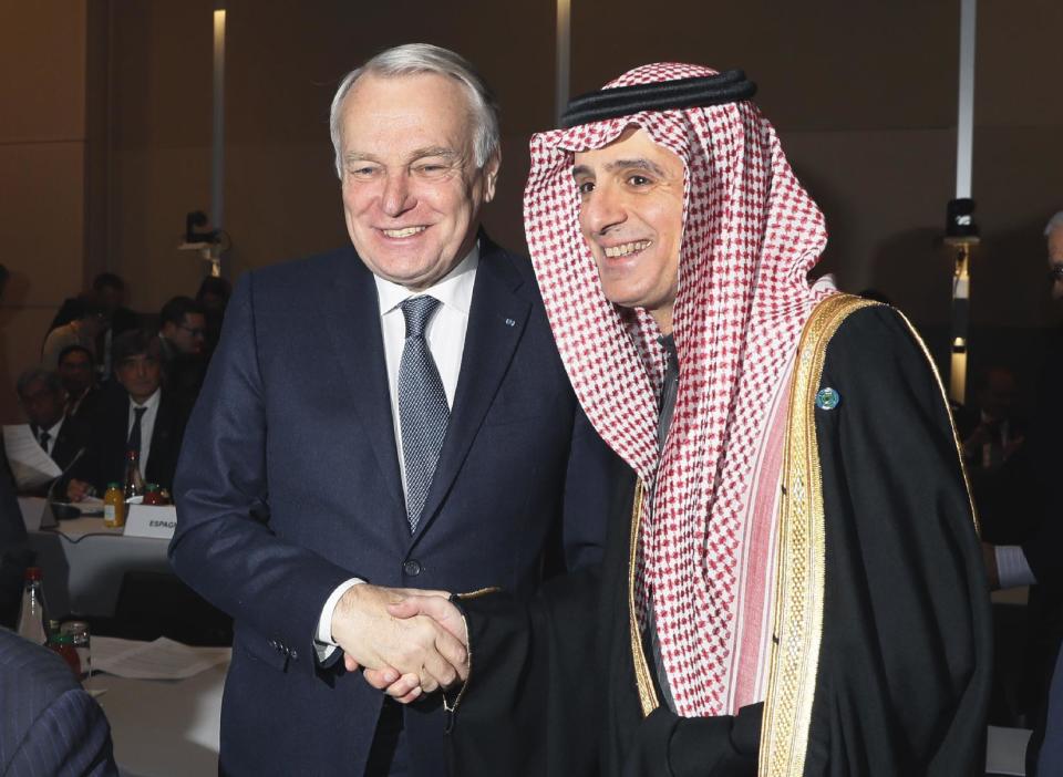 French Minister of Foreign Affairs Jean-Marc Ayrault, left, greets his Saudi counterpart Adel Al-Jubeir at the opening of the Mideast peace conference in Paris, Sunday, Jan. 15, 2017. Fearing a new eruption of violence in the Middle East, more than 70 world diplomats gathered in Paris on Sunday to push for renewed peace talks that would lead to a Palestinian state. (Thomas Samson/Pool Photo via AP)