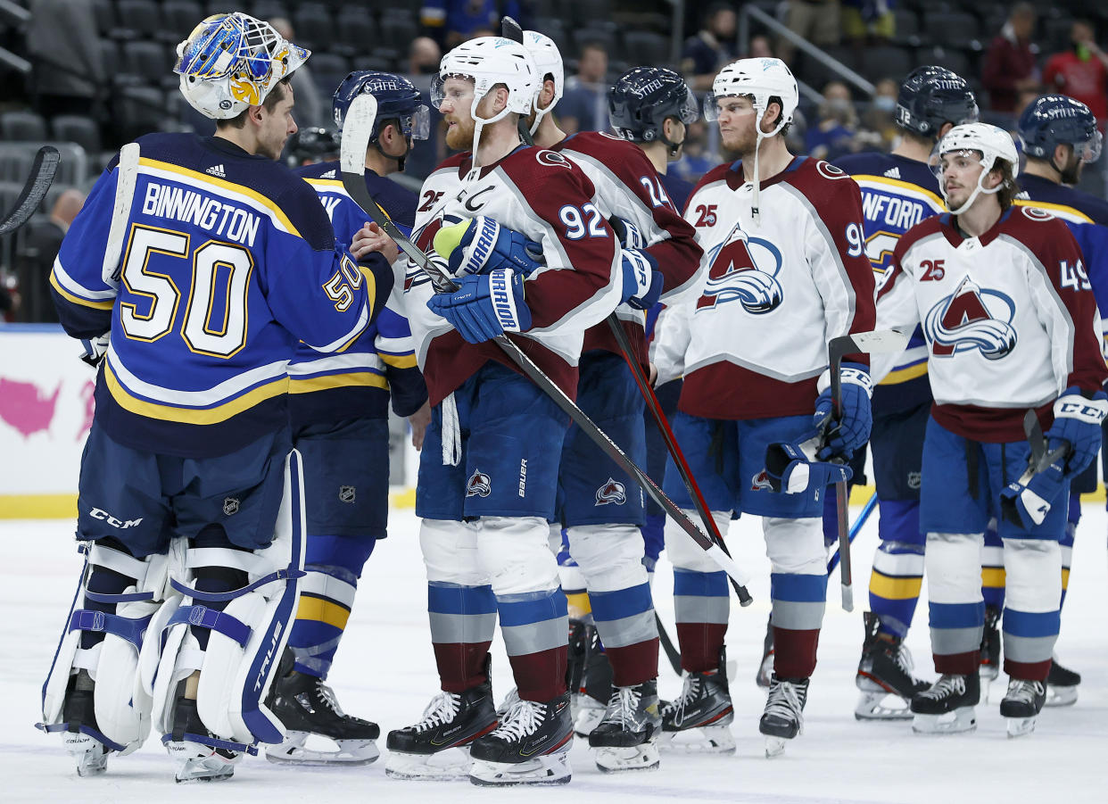 ST LOUIS, MISSOURI - MAY 23: Jordan Binnington #50 of the St. Louis Blues shakes hands with Gabriel Landeskog #92 of the Colorado Avalanche after the Colorado Avalanche beat the St. Louis Blues 5-2 at Enterprise Center on May 23, 2021 in St Louis, Missouri. (Photo by Tom Pennington/Getty Images)