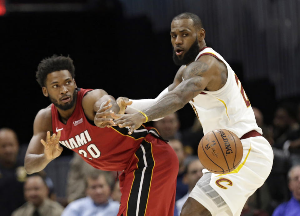 LeBron James plays tight defense against Justise Winslow on Tuesday. (AP)