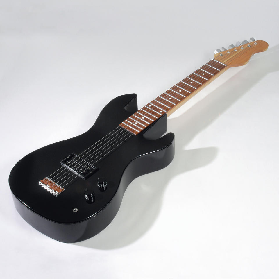 A coffin in the shape of a guitar. (Photo: Caters News)