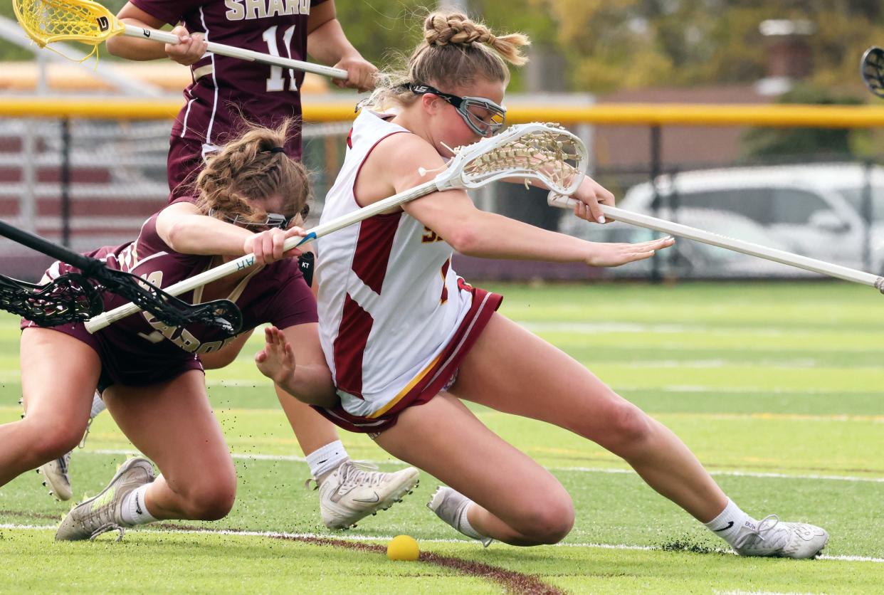 Cardinal Spellman's Erin O'Donnell was tripped by Sharon defender Avery Birnbaum during a game on Friday, April 28, 2023. 