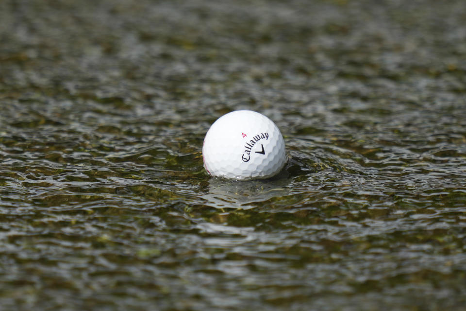 Emiliano Grillo's ball floats down a concrete drainage canal on the 18th hole during the final round of the Charles Schwab Challenge golf tournament at Colonial Country Club in Fort Worth, Texas, Sunday, May 28, 2023. (AP Photo/LM Otero)