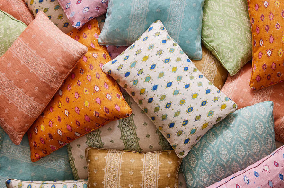 Pillows upholstered in Fez in Terracotta (far left) and Oona in Orange/Pink and Indigo/Olive on Natural (center) by Peter Dunham Textiles