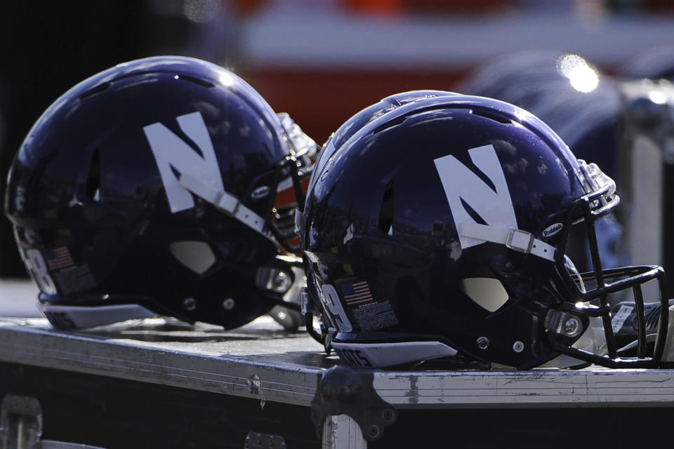 FILE - Northwestern helmets are shown during an NCAA college football game against Iowa in Evanston, Ill., Saturday, Oct. 17, 2015. At Northwestern, allegations of hazing in the football program led to the firing of longtime coach Pat Fitzgerald, and has the school facing multiple lawsuits with more likely. (AP Photo/Matt Marton, File)