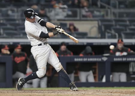 Mar 31, 2019; Bronx, NY, USA; New York Yankees second baseman DJ LeMahieu (26) hits an RBI single during the bottom of the ninth inning against the Baltimore Orioles at Yankee Stadium. Mandatory Credit: Vincent Carchietta-USA TODAY Sports