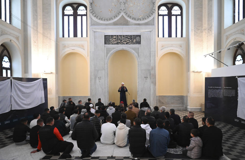 The imam leads the morning prayers at the historic Yeni Cami, or New Mosque, in the port city of Thessaloniki, northern Greece, Wednesday, April 10, 2024. Eid prayers were held in the historic former mosque in northern Greece for the first time in 100 years. (AP Photo/Giannis Papanikos)