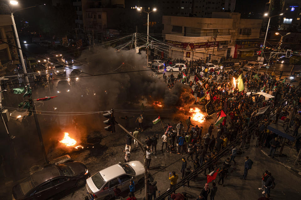 Palestinians celebrate after a shooting attack near a synagogue in Jerusalem, in Gaza City, Friday, Jan. 27, 2023. A Palestinian gunman opened fire outside an east Jerusalem synagogue Friday night, killing seven people, including a 70-year-old woman, and wounding three others before police shot and killed him, officials said. It was the deadliest attack on Israelis in years and raised the likelihood of further bloodshed.(AP Photo/Fatima Shbair)