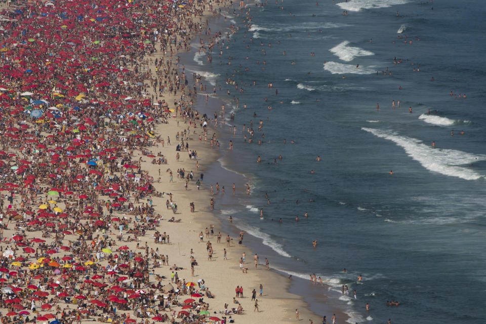 This Sept. 7, 2012 photo shows sunbathers at Ipanema beach in Rio de Janeiro, Brazil. Rio boasts some of the world's most stunning urban beaches and they're worth several visits. (AP Photo/Felipe Dana)