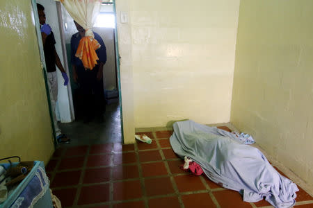 FILE PHOTO: The covered body of a dead person is seen after Venezuelan soldiers opened fire on indigenous people near the border with Brazil on Friday, according to community members, in Kumarakapay, Venezuela, February 22, 2019. REUTERS/William Urdaneta/File Photo