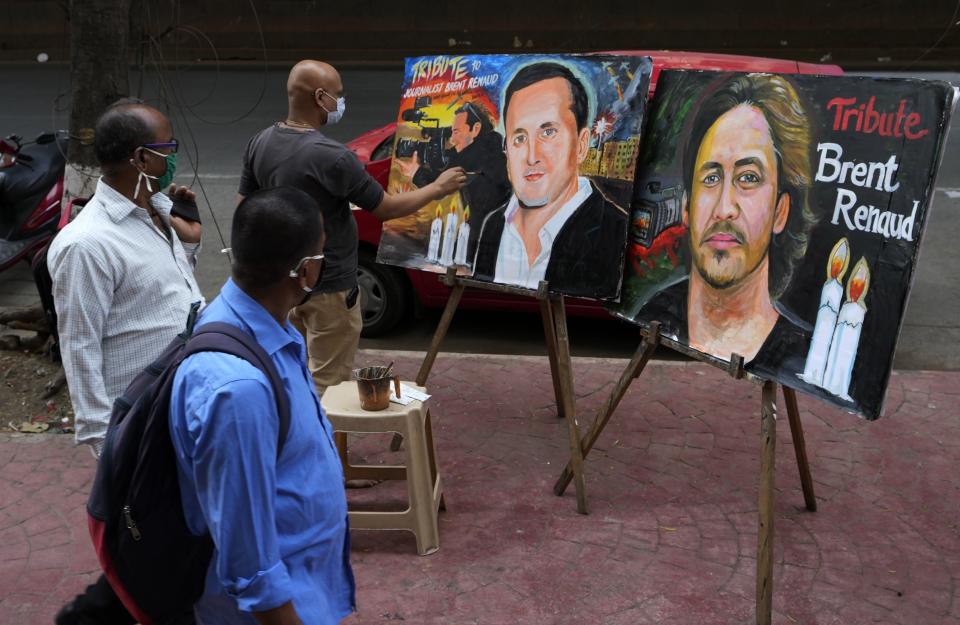 Artist Sagar Kambli paints two portraits of journalist Brent Renaud in India on Monday.