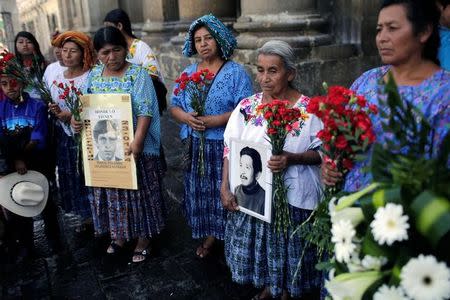 Family members and activists stand around a coffin which contains the remains of Jacobo Perez, who disappeared during the civil war, as International Day of the Victims of Enforced Disappearances is observed in Guatemala City, Guatemala, August 30, 2016. REUTERS/Saul Martinez