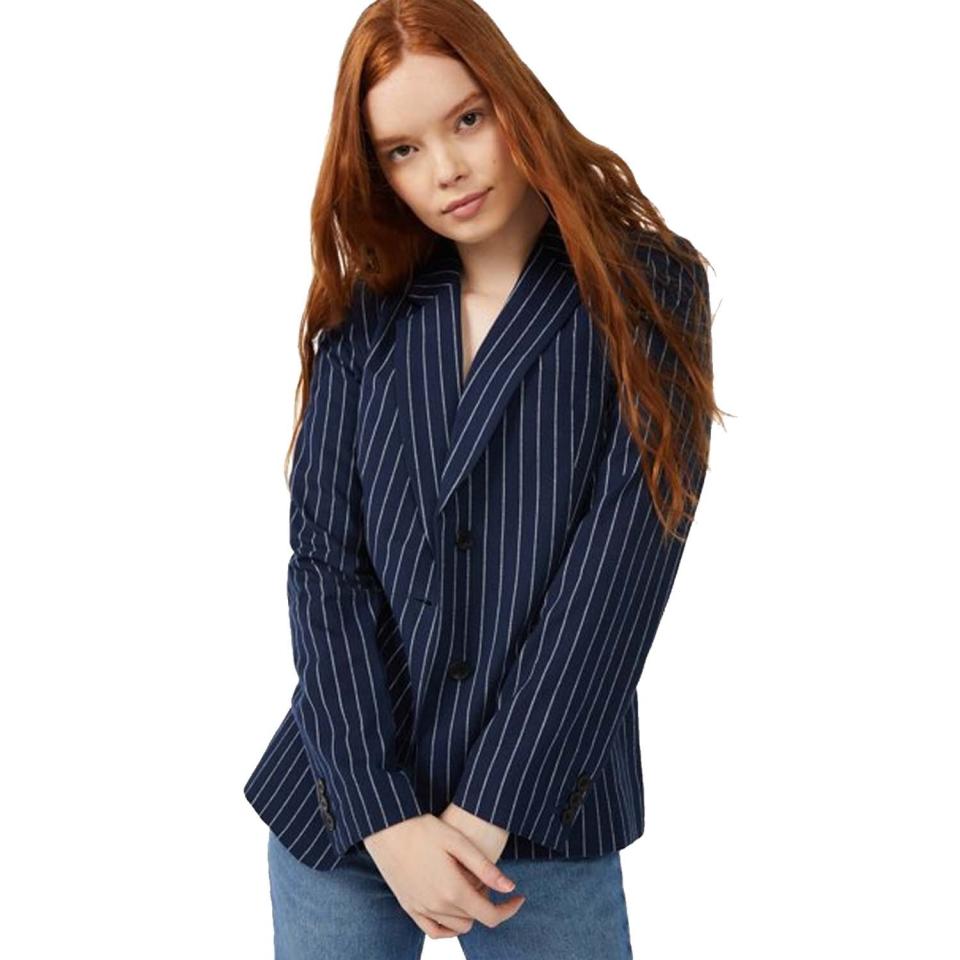 woman wearing navy pinstripe blazer with blue jeans