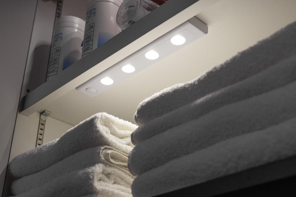 The bar light used under a shelf in a linen closet