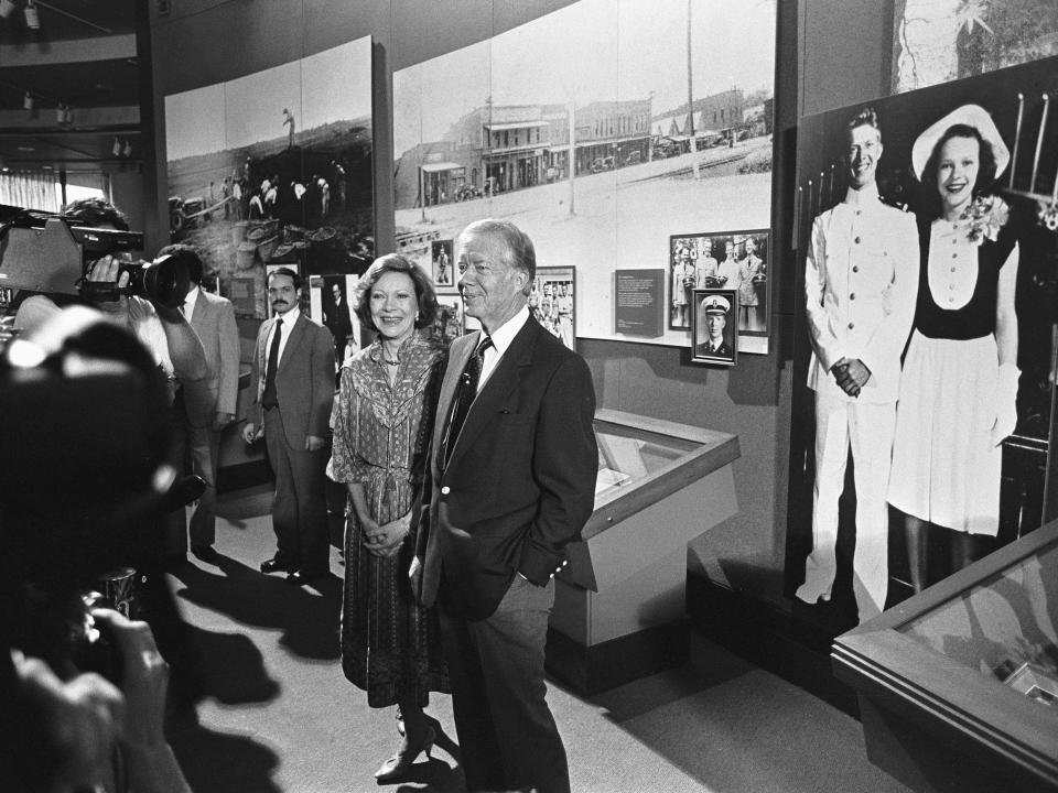 Jimmy Carter, and his wife, Rosalynn, give members of the press a tour at a special preview of the new Carter Presidential Center in 1986