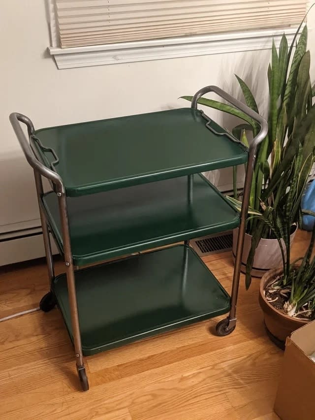 The cart after with chrome finishes on the handles and dark green enamel trays