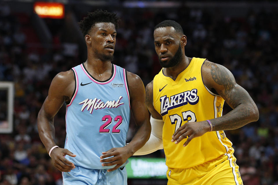 LeBron James (right) is looking to oust Jimmy Butler from the playoffs with a third different team. (Michael Reaves/Getty Images)