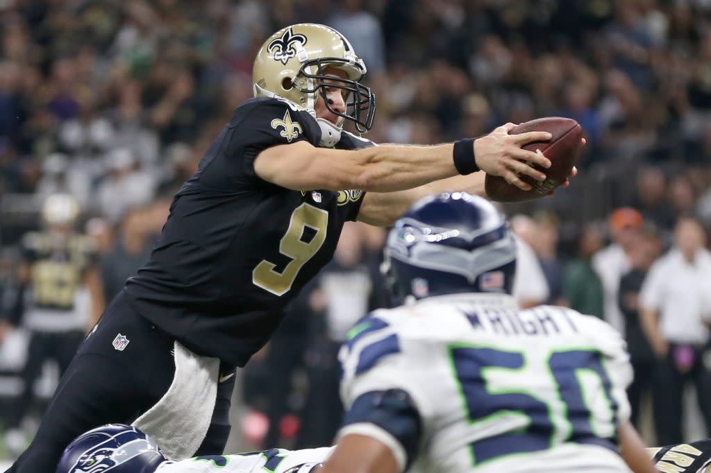 Oct 30, 2016; New Orleans, LA, USA; New Orleans Saints quarterback Drew Brees (9) leaps over the line for a one-yard touchdown run in the second quarter against the Seattle Seahawks at the Mercedes-Benz Superdome. Mandatory Credit: Chuck Cook-USA TODAY Sports