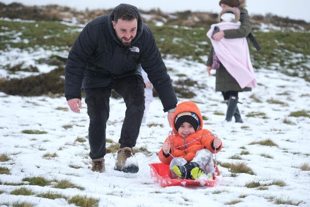 Jack Campbell pushes his son Harvey on a sledge