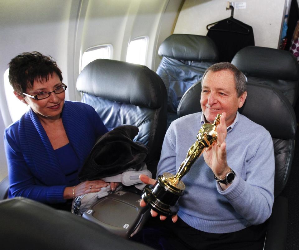 FILE - In this Feb. 9, 2012 file photo, Academy of Motion Picture Arts and Sciences president Tom Sherak, right, and his wife Madeleine pose with a Oscar statue after landing at Los Angeles International Airport as they arrive from Chicago, in Los Angeles. Sherak, a former Academy of Motion Picture Arts and Sciences president, has died of prostate cancer at 68, the Academy confirmed on Tuesday, Jan. 28, 2014. Sherak was surrounded family at his home in Calabasas, Calif. (AP Photo/Chris Carlson, File)