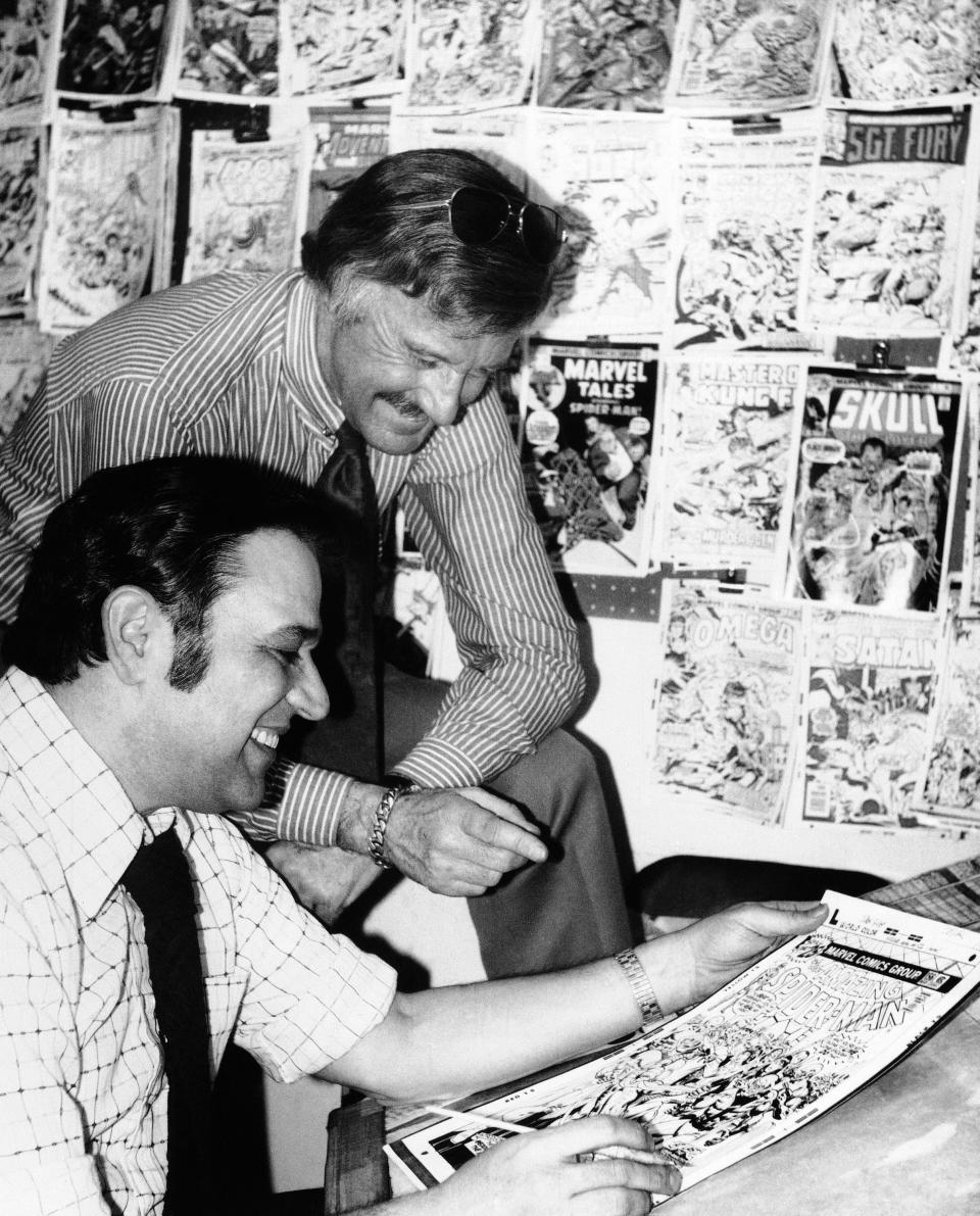 In this Jan. 10, 1976, Stan Lee, publisher of Marvel Comics, discusses a "Spider-Man" comic book cover with artist John Romita at Marvel headquarters in New York.