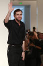 French fashion designer Christophe Lemaire waves after the presentation of Hermes' ready to wear Spring-Summer 2013 collection, presented in Paris, Sunday, Sept.30, 2012. (AP Photo/Thibault Camus)