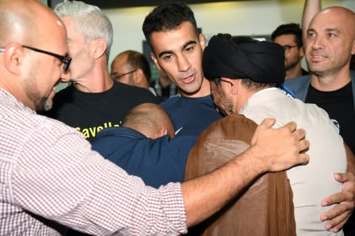 Hakeem al-Araibi (C) was greeted by a throng of well wishers at Melbourne Airport after an overnight flight to freedom