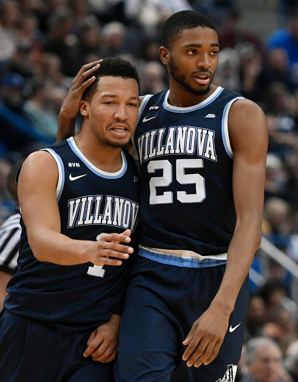 Villanova's Jalen Brunson, left, is embraced by teammate Mikal Bridges during the second half of an NCAA college basketball game against Connecticut, Saturday, Jan. 20, 2018, in Hartford, Conn. (AP Photo/Jessica Hill)