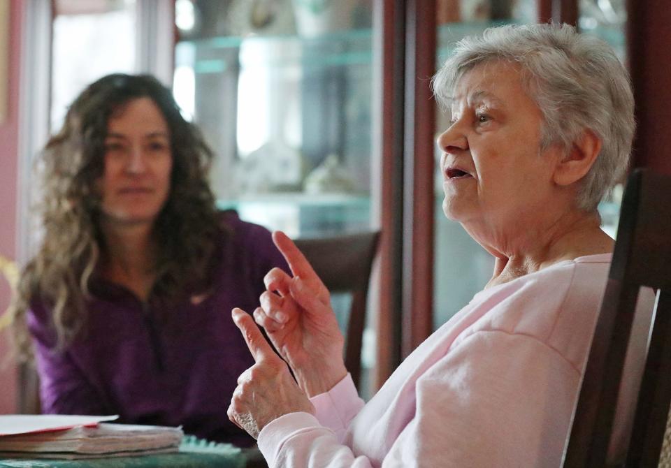 Liz Tucci listens as her mother, Elizabeth Varga, talks at her Fairlawn home about the mattress a salesman told her she could return, only to find out the fine print said otherwise.