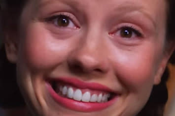 Mia goth smiling intensely