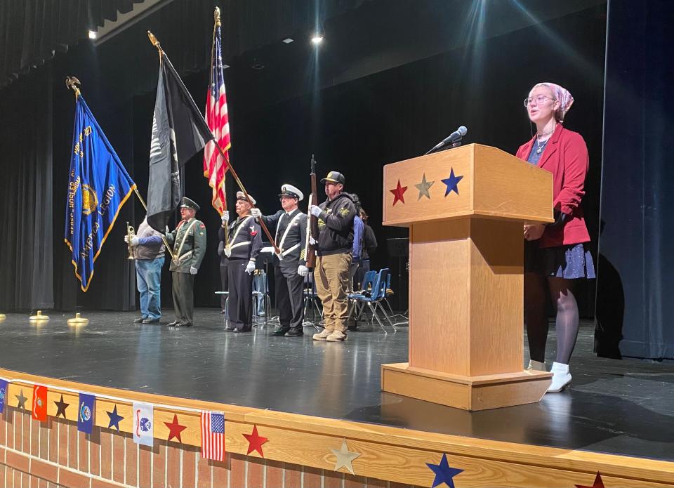 East Jordan High School Senior Zoe Bunker sings the national anthem during a Veterans Day assembly, an event that was planned and organized by the Shoe Club.