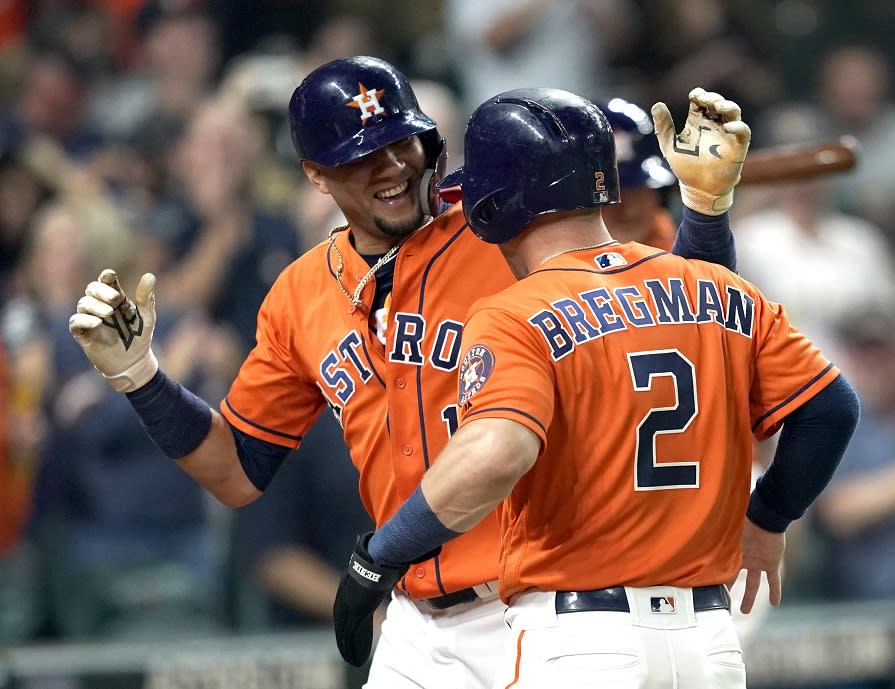 Yuli Gurriel (left) celebrates his grand slam with Alex Bregman. The Astros clinched a postseason with Friday’s win. (AP)