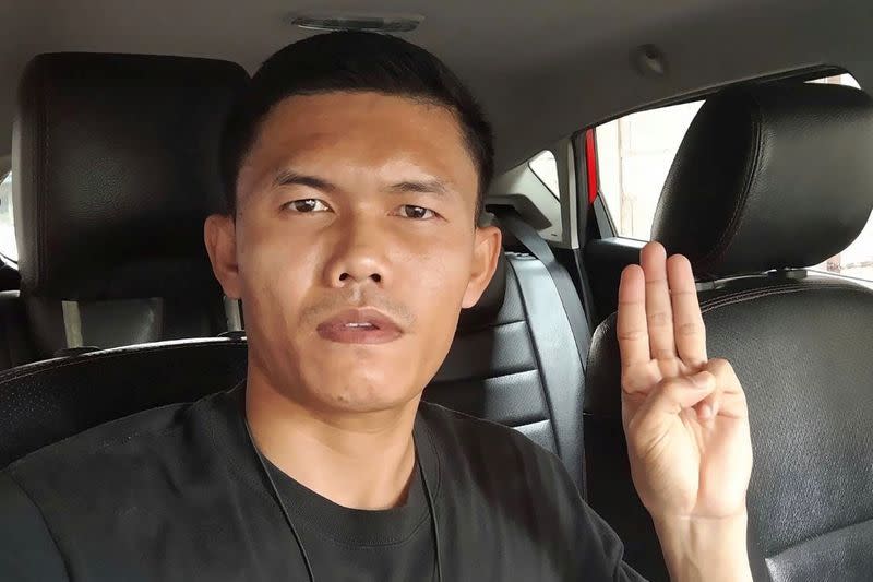 Former Thai Army Sergeant Ekkachai Wangkaphan poses with the three-fingered salute of anti-government protesters in this image he took in Bung Kan, Thailand