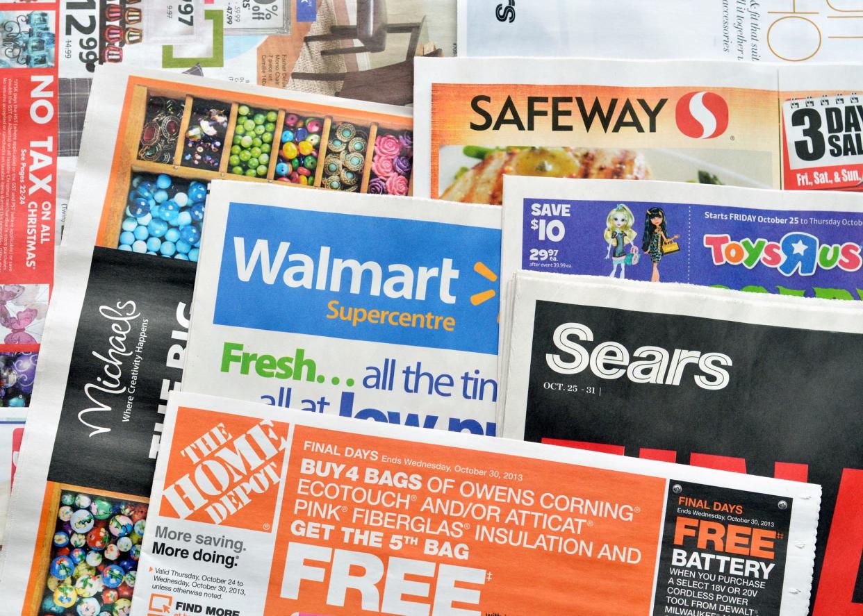 Vancouver, Canada -- October 23, 2013:Close up of  a pile of weekly retail advertisements from major retailers such as Walmart, the Home Depot, Sears, Safeway and Michaels.