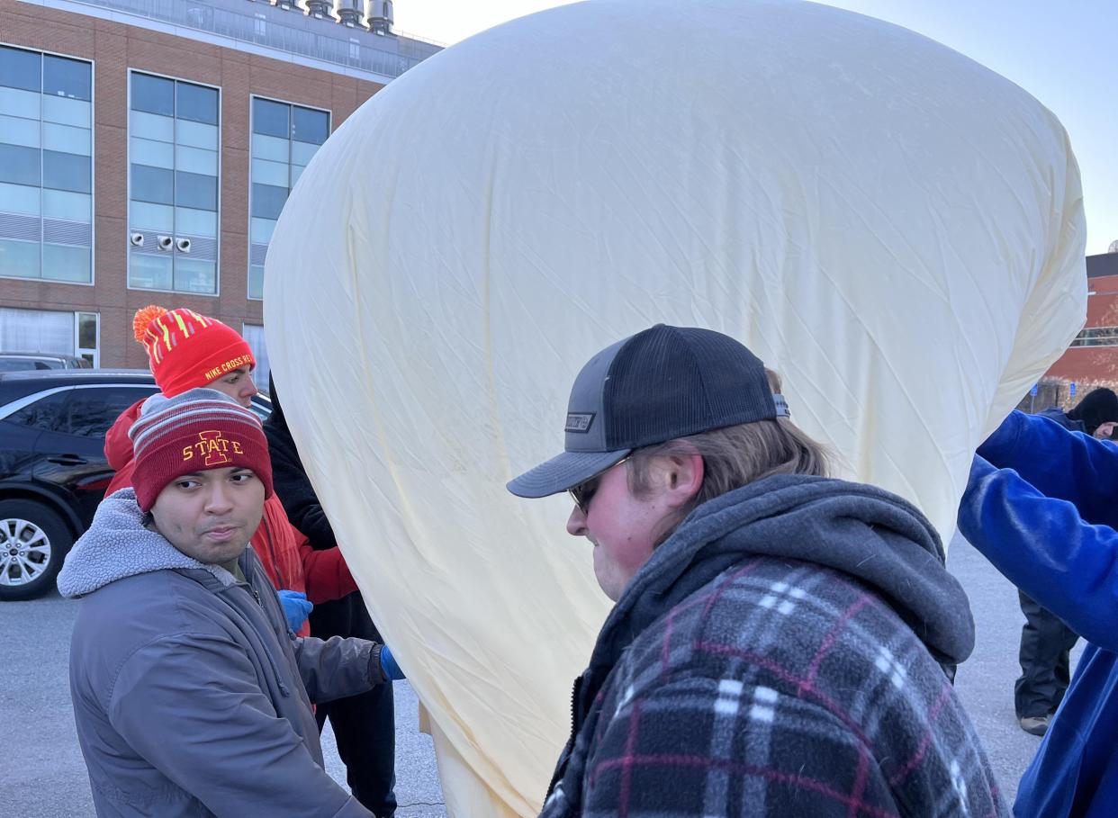 Iowa State University students inflate a high-altitude balloon and prepare for launch in the Howe Hall parking lot on March 23. The launch will prepare them for a similar experiment during the upcoming solar eclipse.