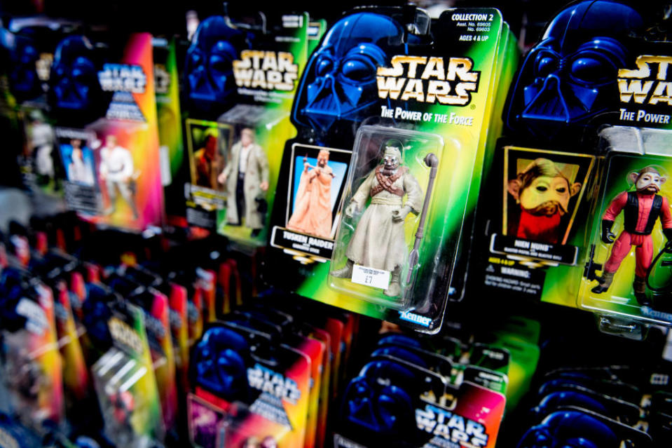 Star Wars action figures in packaging are displayed on shelves