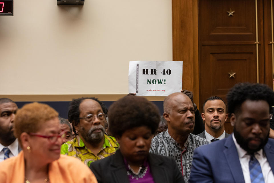 An attendee holds up a sign in support of HR 40, during the hearing on reparations for the descendants of slaves, before the House Judiciary Subcommittee on the Constitution, Civil Rights and Civil Liberties, on June 19, 2019. (Cheriss May/NurPhoto via Getty Images)