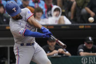 Texas Rangers' Marcus Semien hits a two-run single during the 10th inning of the team's baseball game against the Chicago White Sox in Chicago, Saturday, June 11, 2022. The Rangers won 11-9. (AP Photo/Nam Y. Huh)