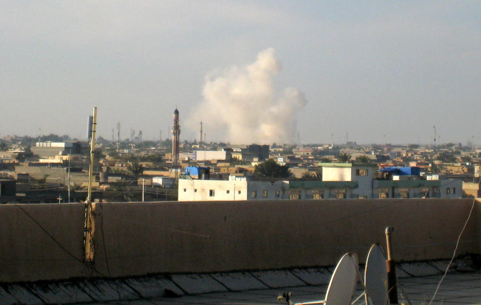 Smoke rises after a bombing in Fallujah, 40 miles (65 kilometers) west of Baghdad, Iraq, Sunday, Jan. 19, 2014. Violence across Iraq, including a series of car bombings and fighting between militants and government troops over control of the country's contested Anbar province, killed dozens Saturday, officials said. (AP Photo)