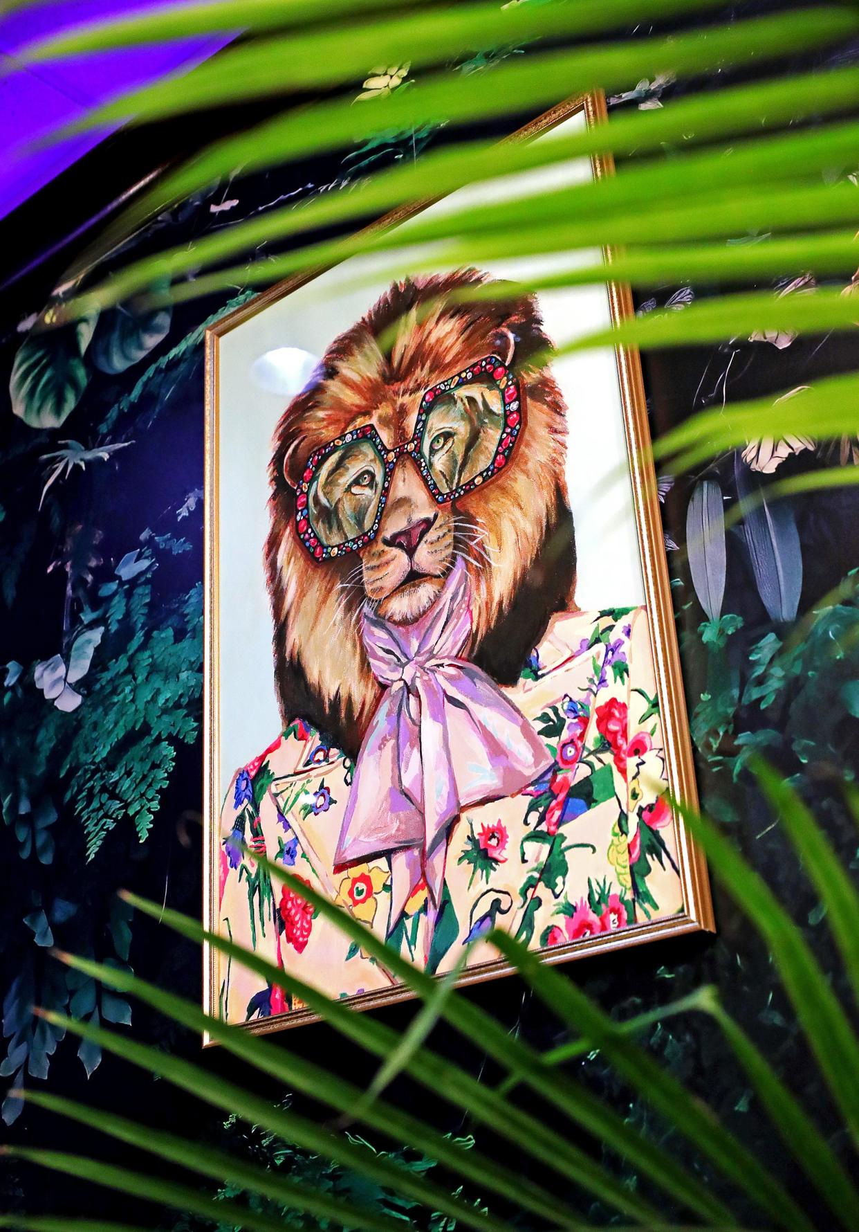 The new Square Scullery restaurant in North Hill has a unique atmosphere that the owner calls jungle disco with pictures of big cats and plants in every corner.