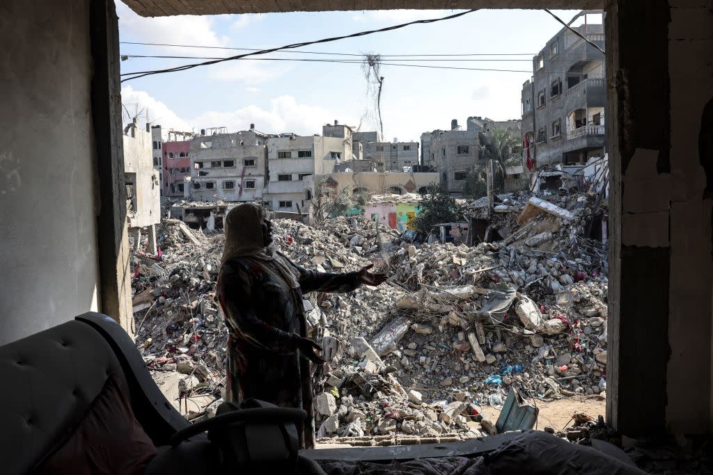  A Palestinian woman gestures as she explains how her home was destroyed duing the Israeli bombardment, in Bureij in the central of Gaza Strip. 