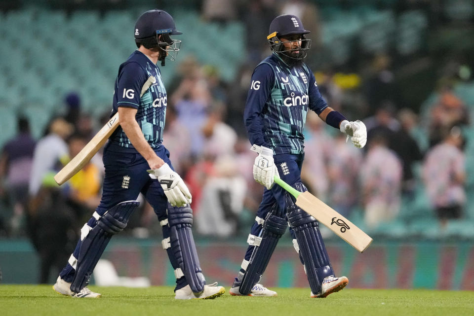 England's Liam Dawson, left, and Adil Rashid walks from the field following the one day cricket international between England and Australia at the Sydney Cricket Ground, in Sydney, Australia, Saturday, Nov. 19, 2022. (AP Photo/Mark Baker)