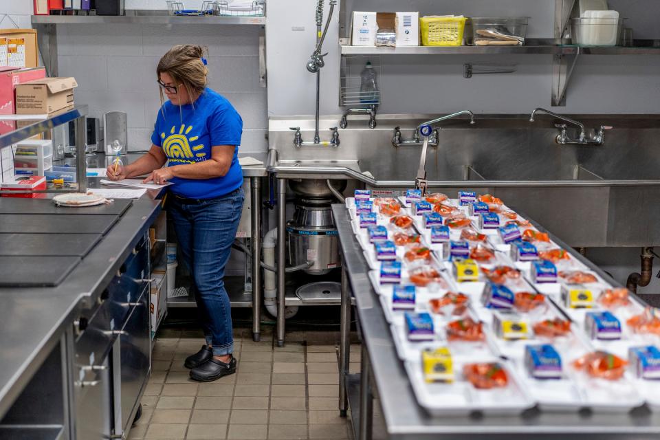 Wilcox Elementary School head cook Kristy Hull prepares items for students' lunches at Wilcox Elementary School in Holt on Wednesday, Nov. 8, 2023. Students at the school are supplied with free lunches as part of the Michigan School Meals project, which makes breakfast and lunch free for all students in public schools.