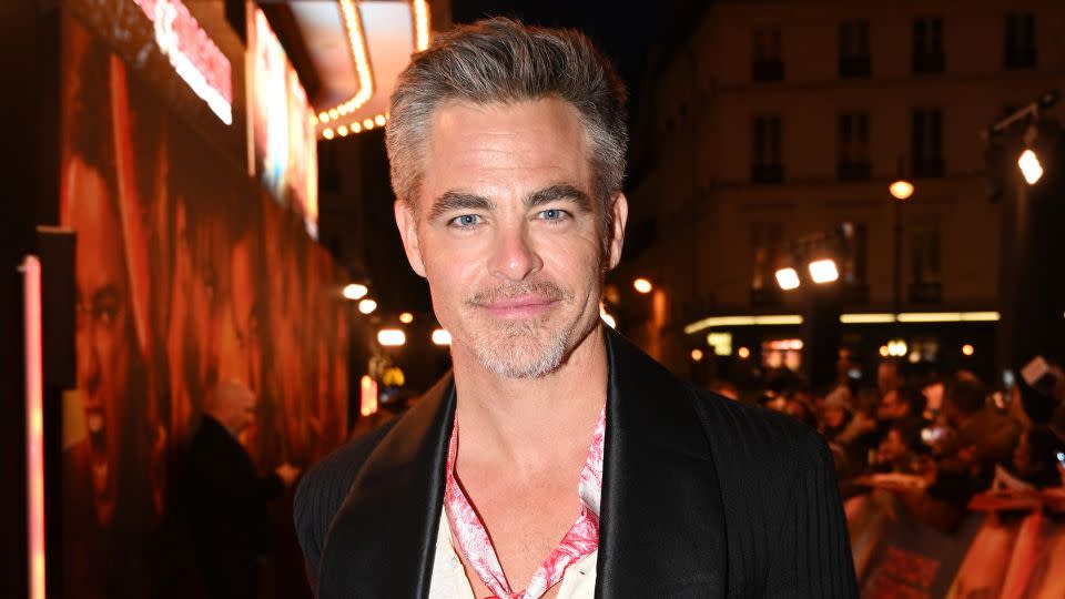 At a "Dungeons & Dragons" movie premiere in Paris on March 22, 2023, Pine paired a tuxedo jacket with a deep V-neck tee and silk scarf. - Anthony Ghnassia/Getty Images