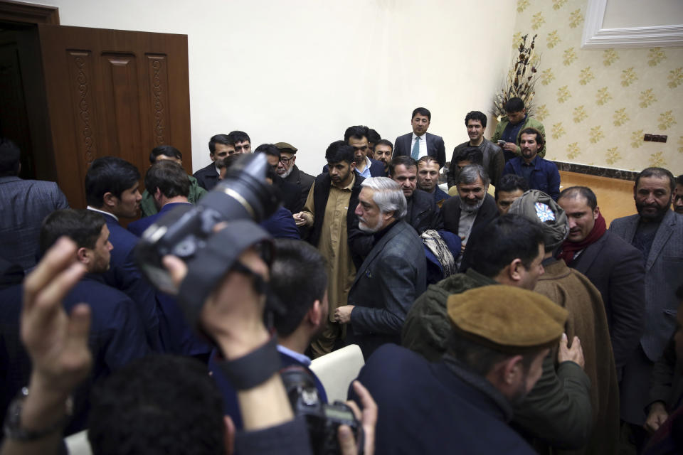 Afghan presidential candidate Abdullah Abdullah, center, leaves after a press conference in Kabul, Afghanistan, Sunday, Dec. 22, 2019. Afghanistan's election commission said the country's incumbent, President Ashraf Ghani, has won a second term in office, according to a preliminary vote count. But his opponents can still challenge the results that were announced on Sunday. (AP Photo/Rahmat Gul)