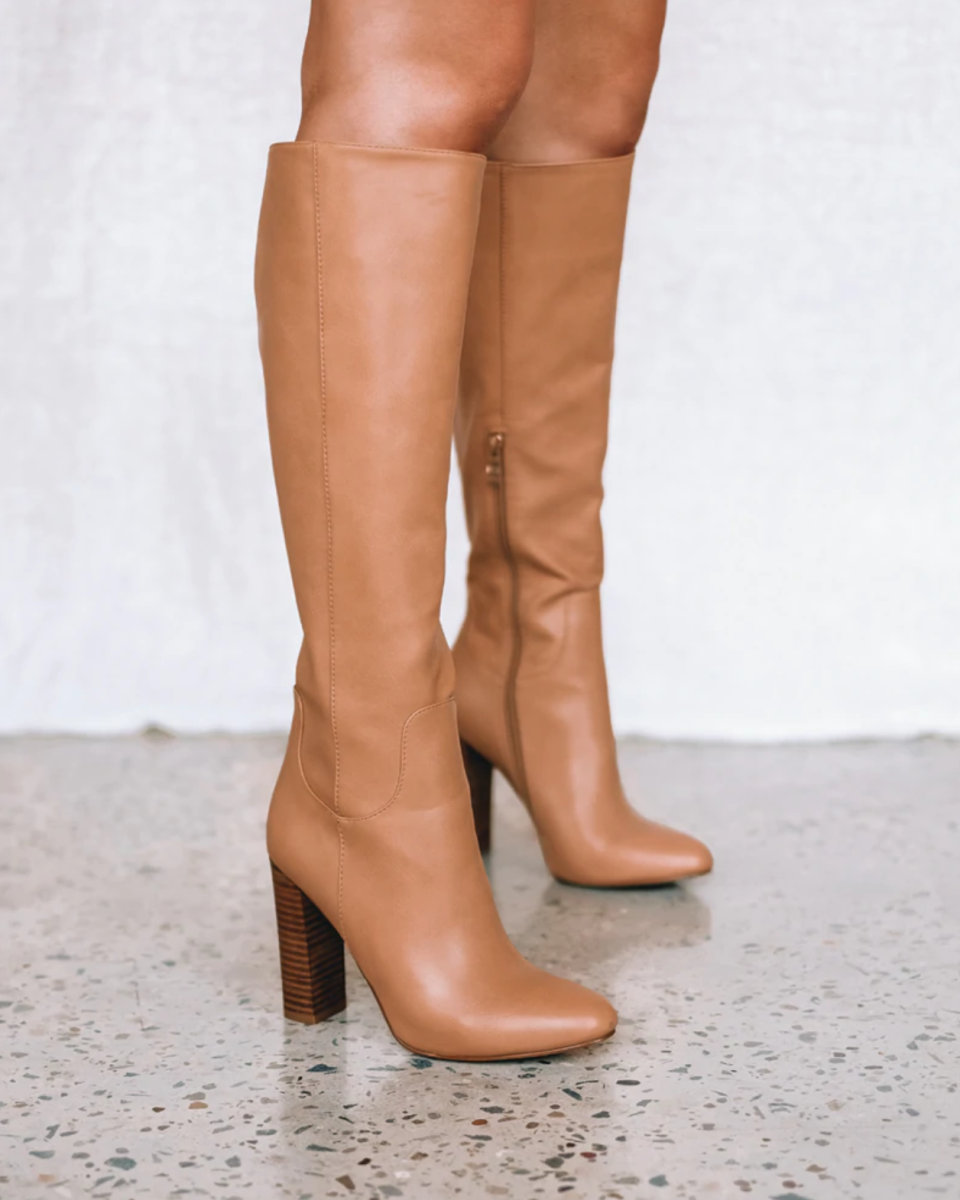 a model's legs shown earing the Pierce Desert by Billini boots in tan leather with high heels.