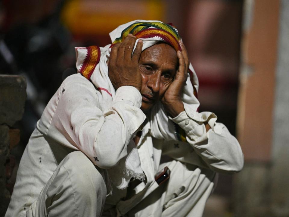 A relative grieves a loved one killed in the Hathras stampede outside a hospital morgue in India’s Uttar Pradesh state on 3 July 2024 (AFP via Getty)