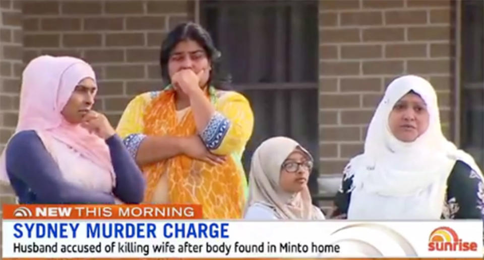 Women weep in the street, mourning a Minto woman who was murdered in her home.